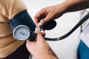 Nurse's hand taking blood pressure of a patient